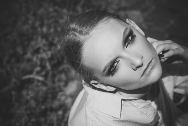 Woman with makeup on young face skin top view