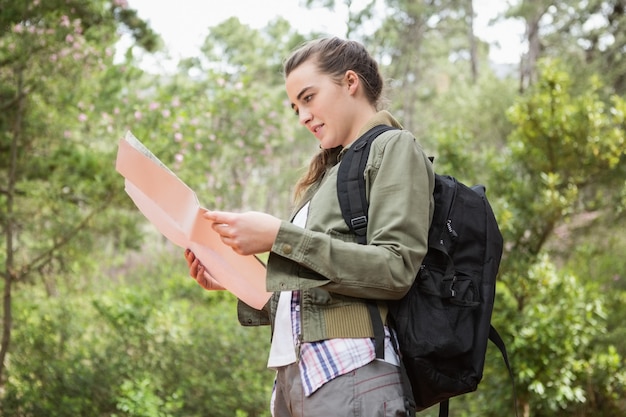 Woman with map and backpack