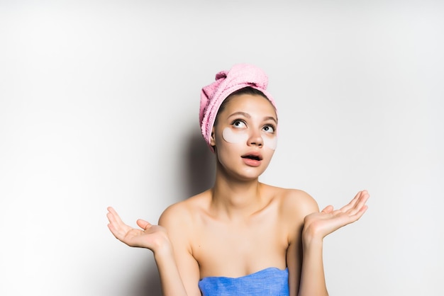 Woman with mask under eye on white