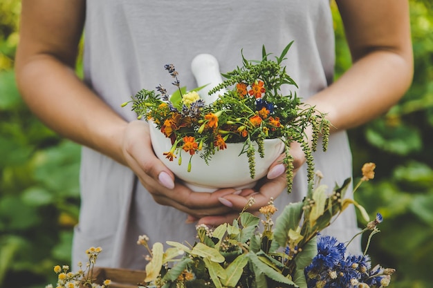 Woman with medicinal herbs and tinctures Selective focus