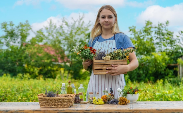 Woman with medicinal herbs and tinctures Selective focus