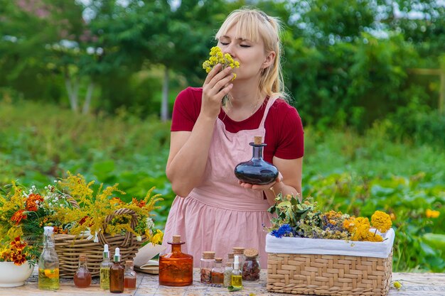 Woman with medicinal herbs and tinctures Selective focus