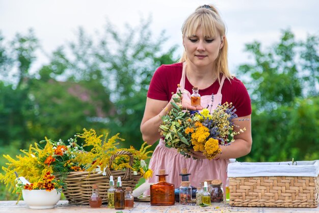 Woman with medicinal herbs and tinctures Selective focus