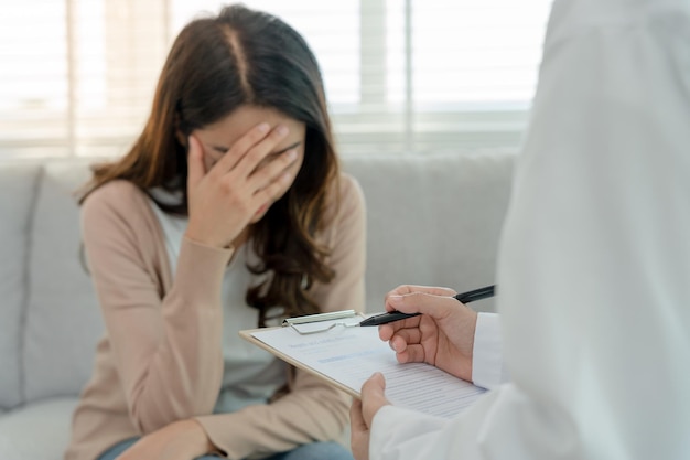 Foto donna con problemi di salute mentale sta consultando uno psichiatra sta registrando le condizioni del paziente per incoraggiare il trattamento amore e problemi familiari depressione bipolare il paziente protegge il suicidio