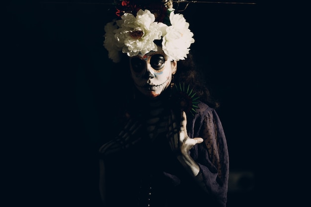 Donna con trucco di halloween teschio messicano sul viso. giorno dei morti aka dia de los muertos e concetto di halloween.