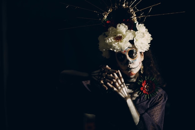 Woman with mexican skull halloween makeup on her face Day of the dead and halloween