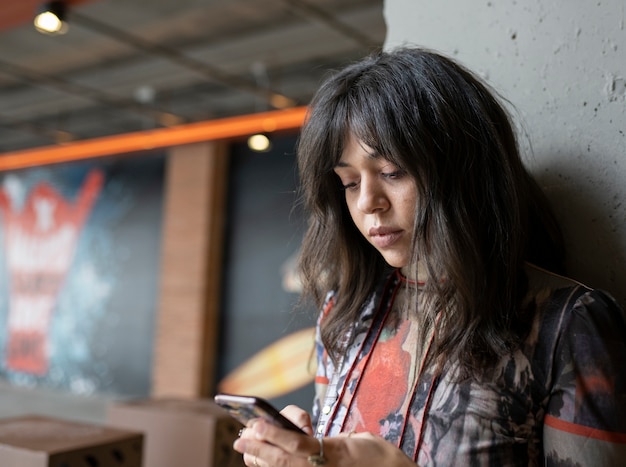 Woman with mobile in a parking lot