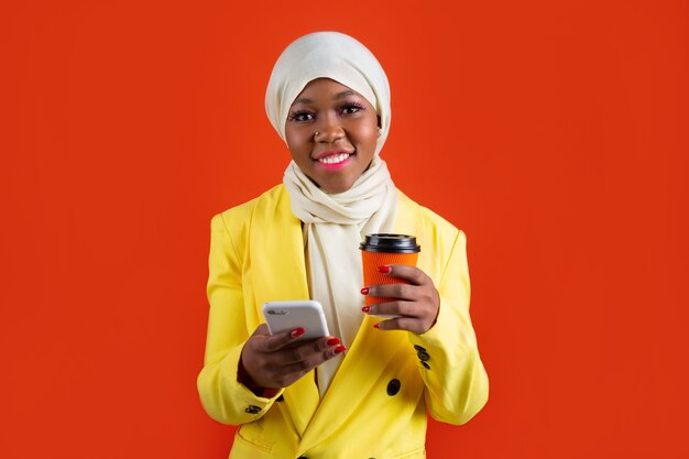 woman with a mobile phone and a cup of coffee