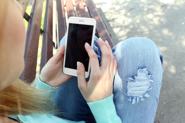 Woman with mobile phone outdoors