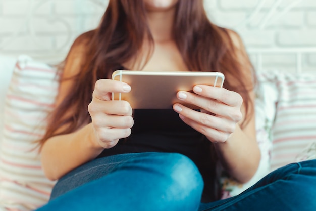 Woman with modern mobile phone in hands 