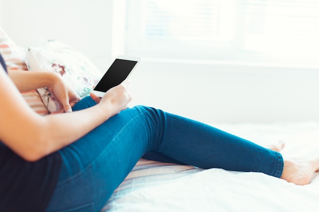 Woman with modern mobile phone in hands