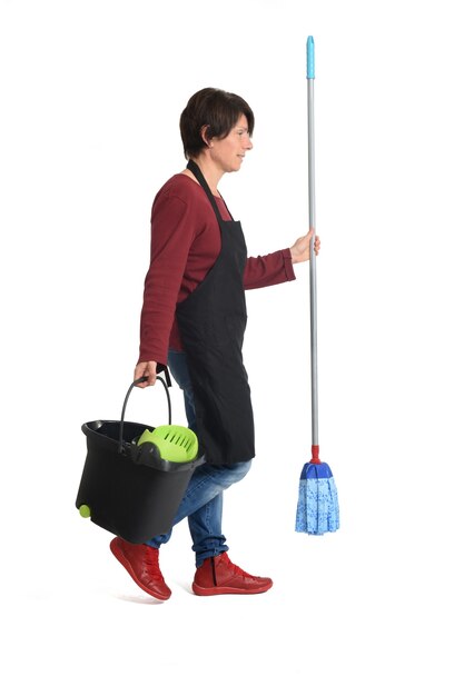 Woman with a mop walking on white
