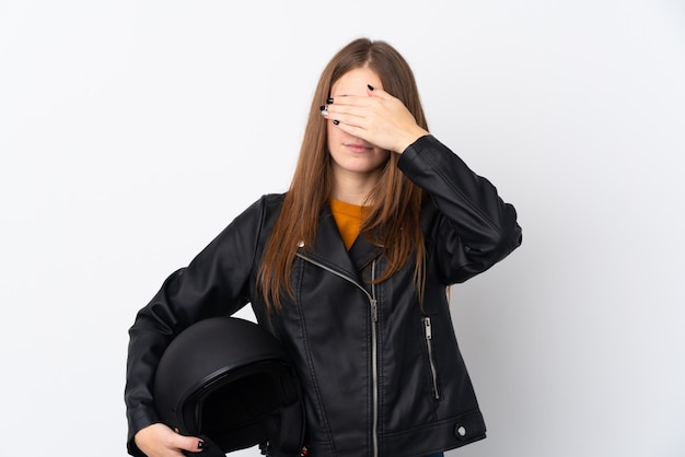 Woman with a motorcycle helmet covering eyes by hands