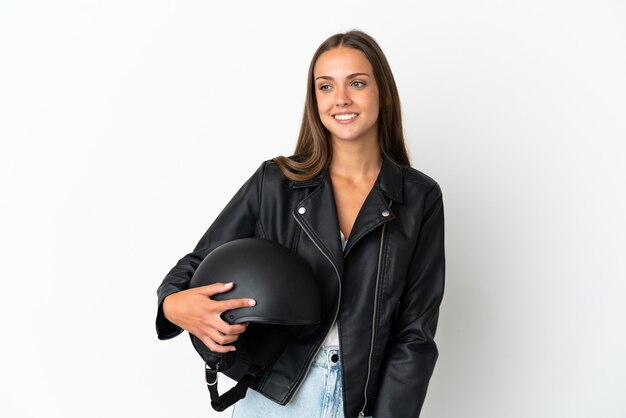 Woman with a motorcycle helmet isolated looking to the side and smiling