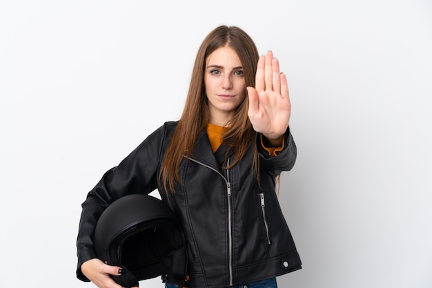 Donna con il casco del motociclo sopra la parete isolata