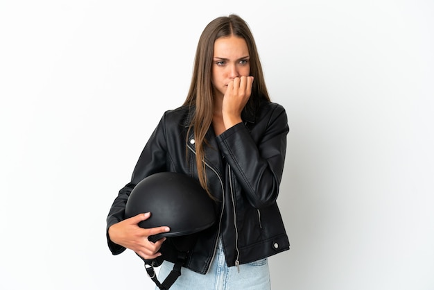 Woman with a motorcycle helmet over isolated white background having doubts