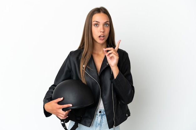 Woman with a motorcycle helmet over isolated white background intending to realizes the solution while lifting a finger up