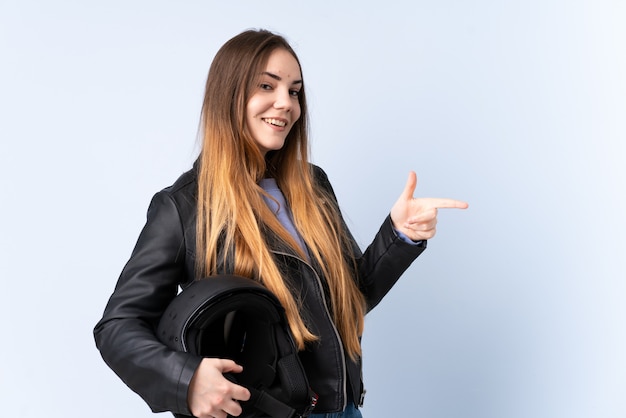 Woman with a motorcycle helmet pointing finger to the side