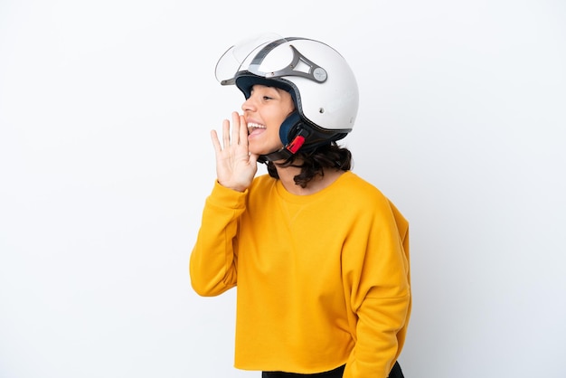 Woman with a motorcycle helmet shouting with mouth wide open to the lateral