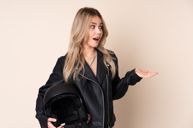 Woman with a motorcycle helmet in studio