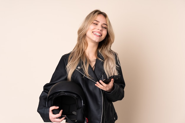 Woman with a motorcycle helmet in studio