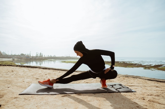 Woman with muslim sport wear stretching