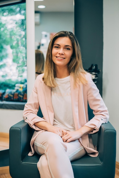 Woman with new hair cut sitting in a hairdresser