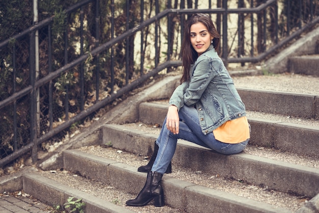 woman with nice hair wearing casual clothes in urban steps.