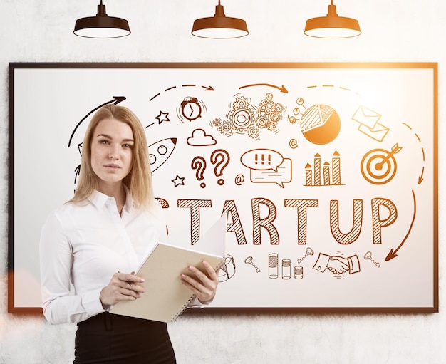 Woman with notebook and startup icons whiteboard