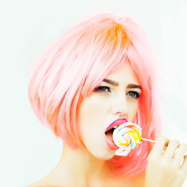 Woman with orange hair lick lollipop
