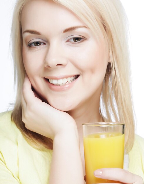 Woman with orange juice on white background