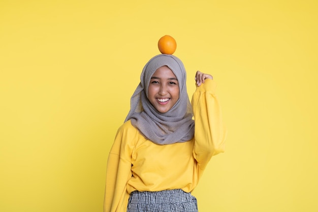 woman with orange on yellow background