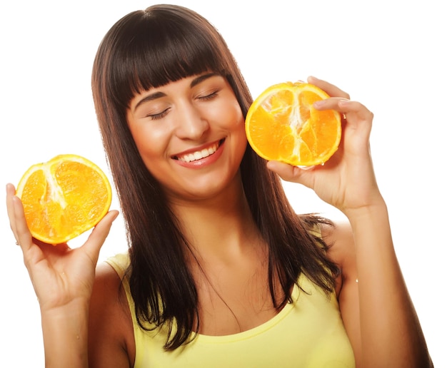 Woman with oranges in her hands studio portrait isolated on whit