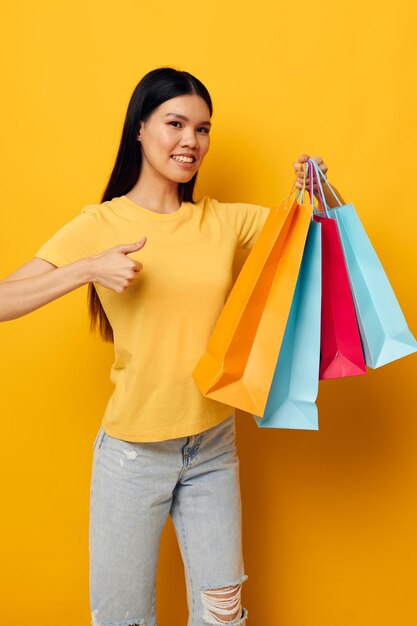 Woman with packages in hands shopping isolated background unaltered person