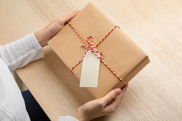 Woman with parcel gift box at table