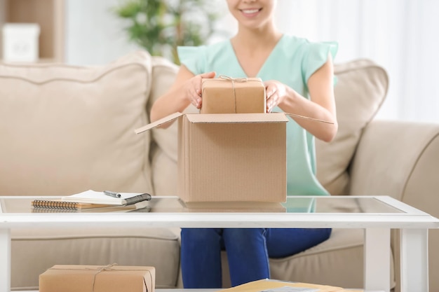 Woman with parcel at home