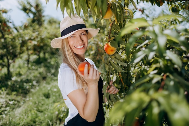 Woman with peach at garden