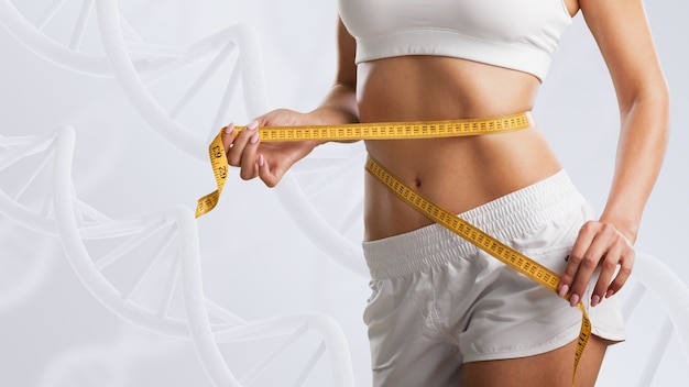 Woman with perfect body near DNA stems. Slimming concept. Improvement of metabolism concept.
