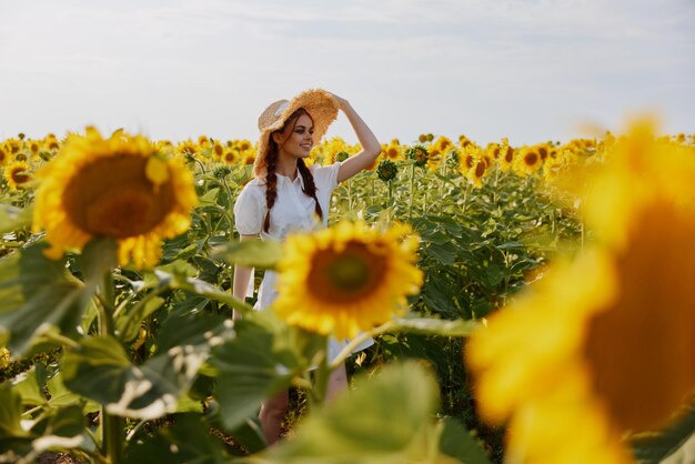 Woman with pigtails looking in the sunflower field landscape high quality photo