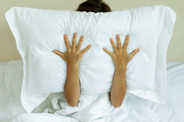 Woman with pillow on her head