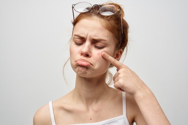 Woman with a pimple on the face hygiene treatment