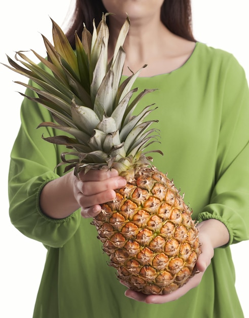 Woman with pineapple in hands on white background