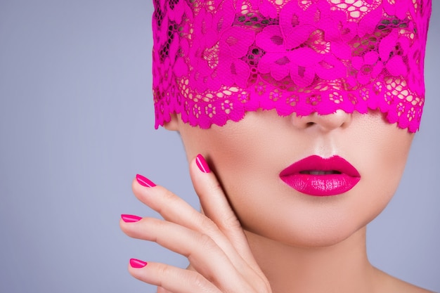 Woman with a pink blindfold on her face