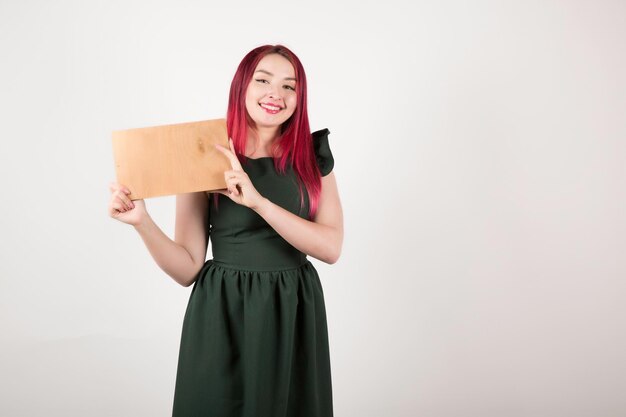 Woman with pink hair holding book