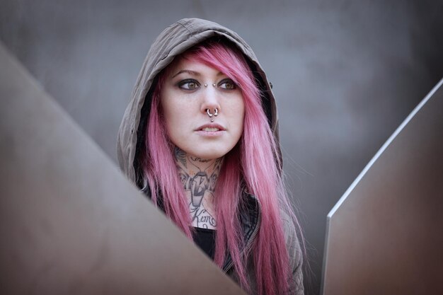 Woman with pink hair piercings and tattoos