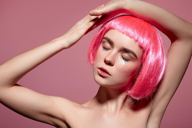Женщина с розовыми волосами позирует