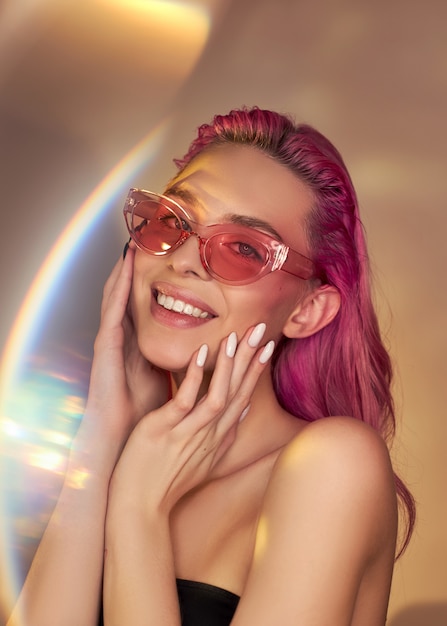 Woman with pink hair and sunglasses