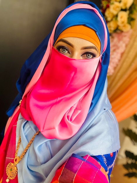 A woman with a pink hijab and a pink head covering