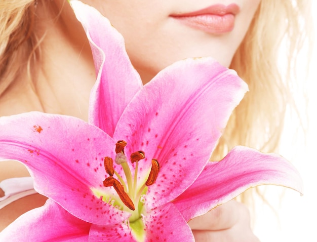 Woman with pink lily highkey portrait