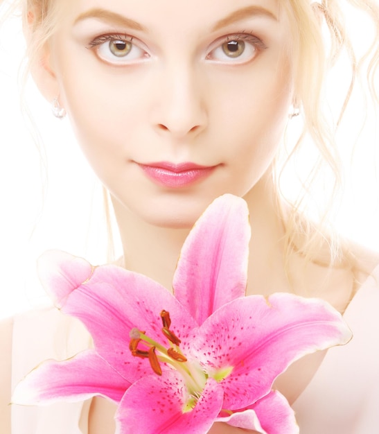 Woman with pink lily highkey portrait